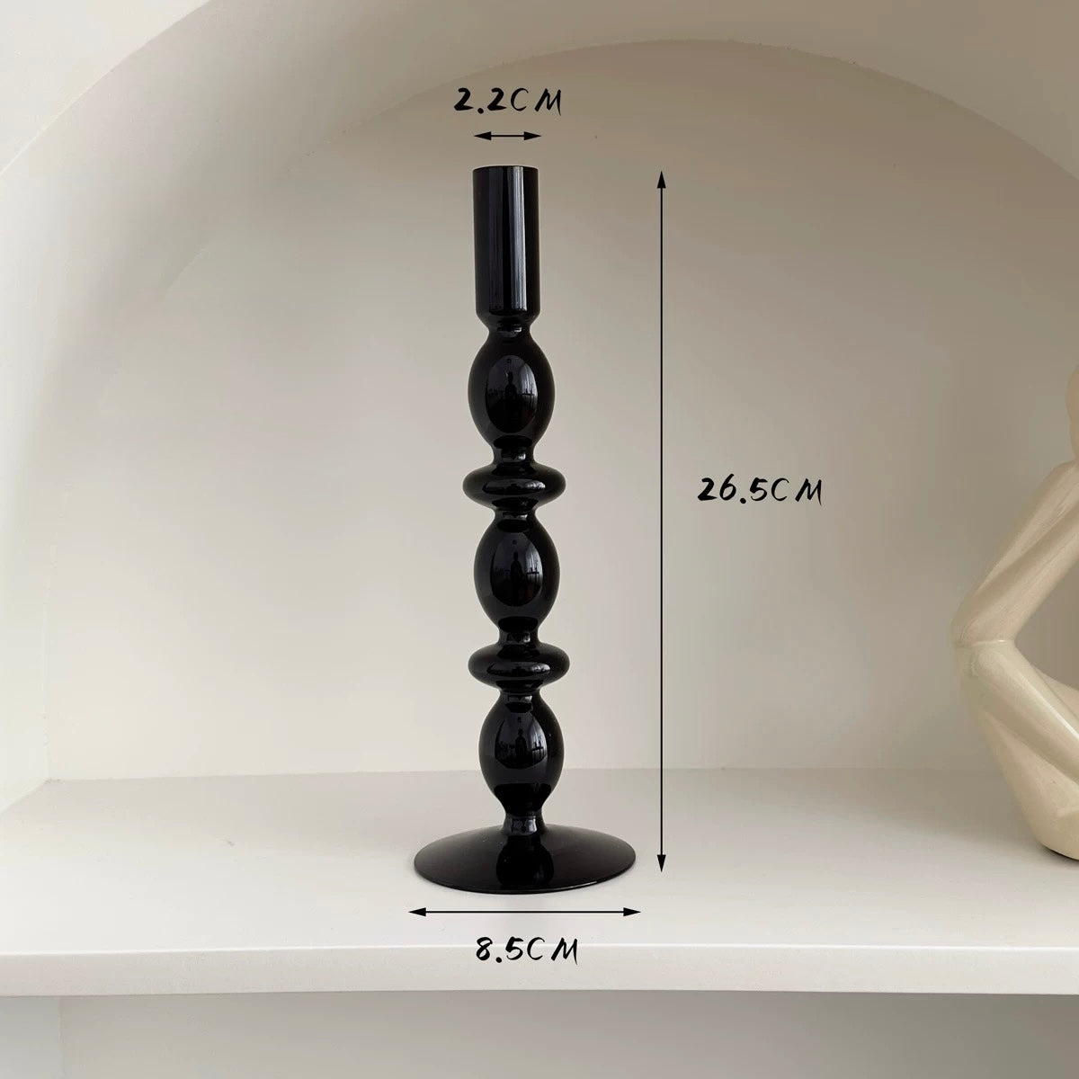 Black candlestick with measurements on a white background