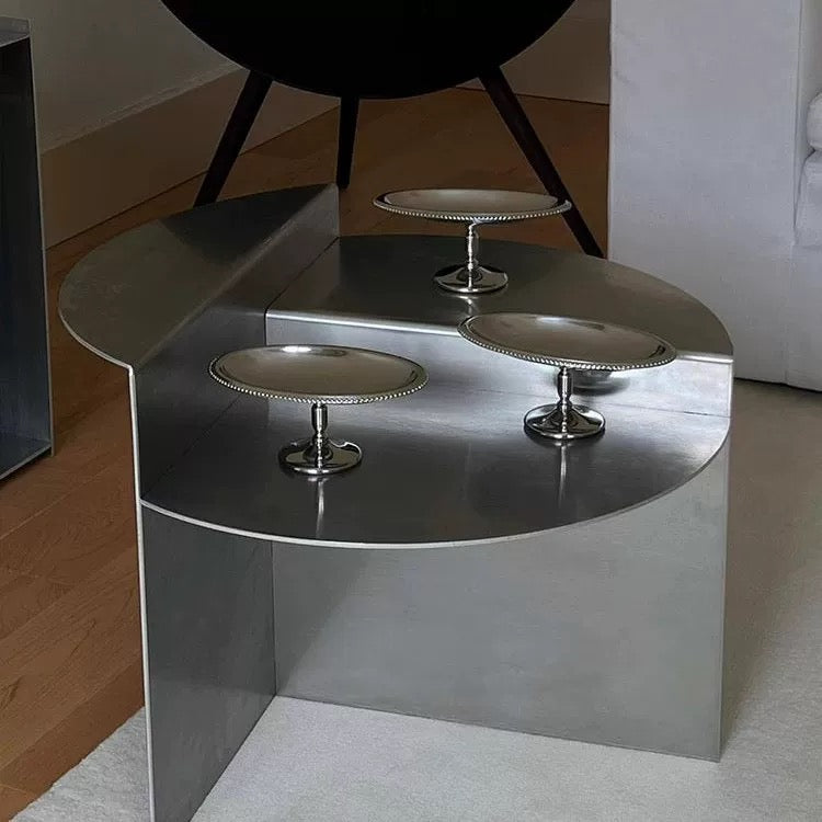 Bauhaus stainless steel coffee table featuring sculptural round design for modern minimalist living room interior styling today.
