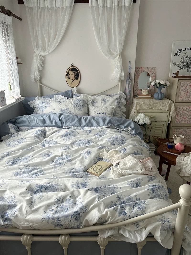 Elegant blue floral duvet cover with lace edges in a shabby chic bedroom.