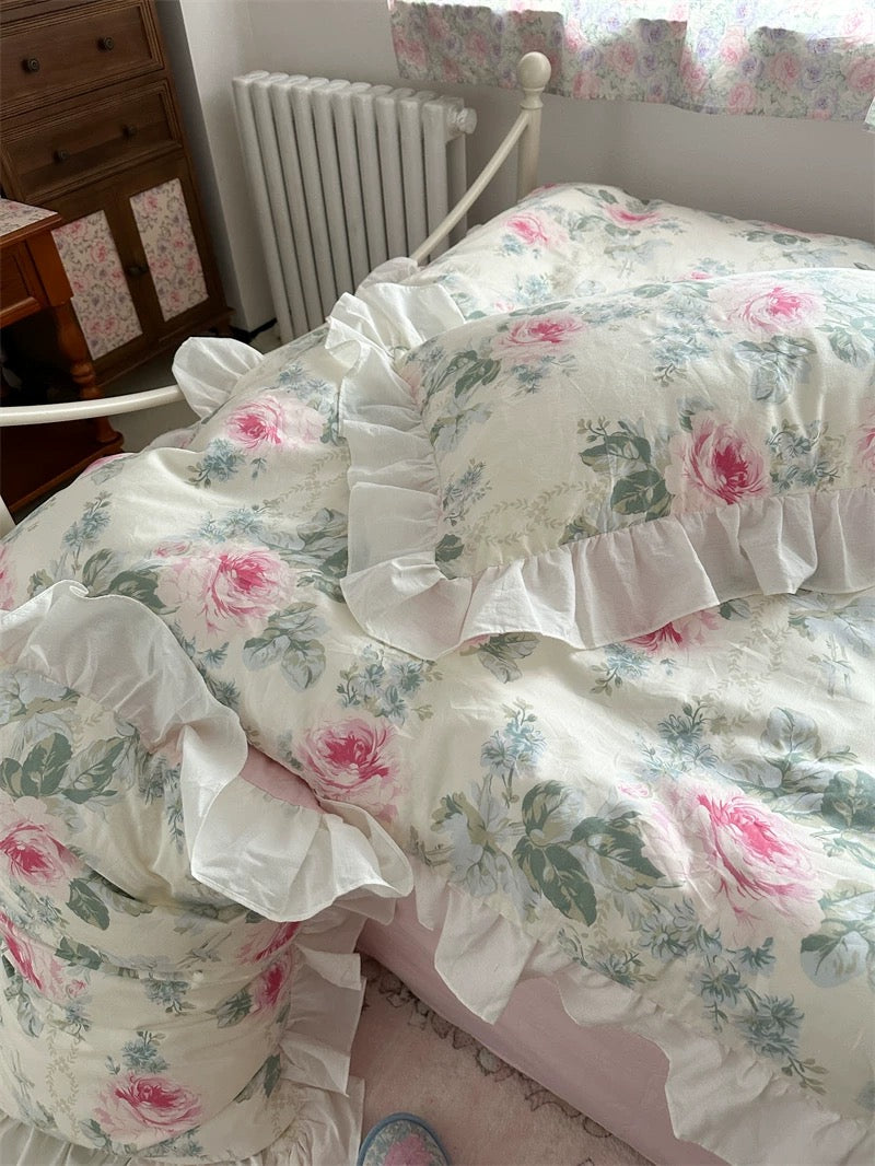 Aesthetic pink floral bedding styled with shabby chic decor and pastel accents.