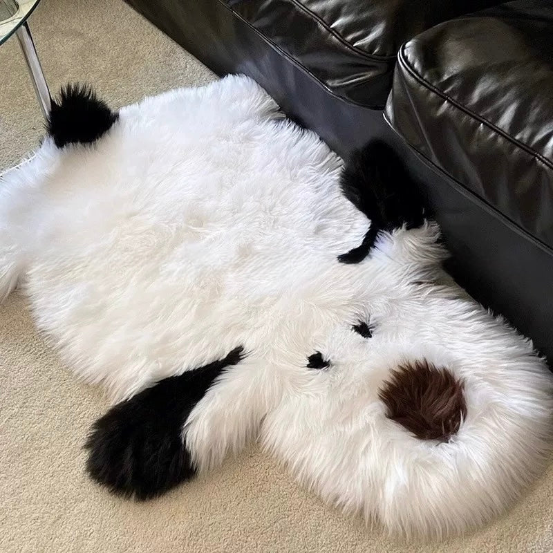 A shaggy dog rug lies beside a black sofa, showing long white strands, black ears and a brown nose.