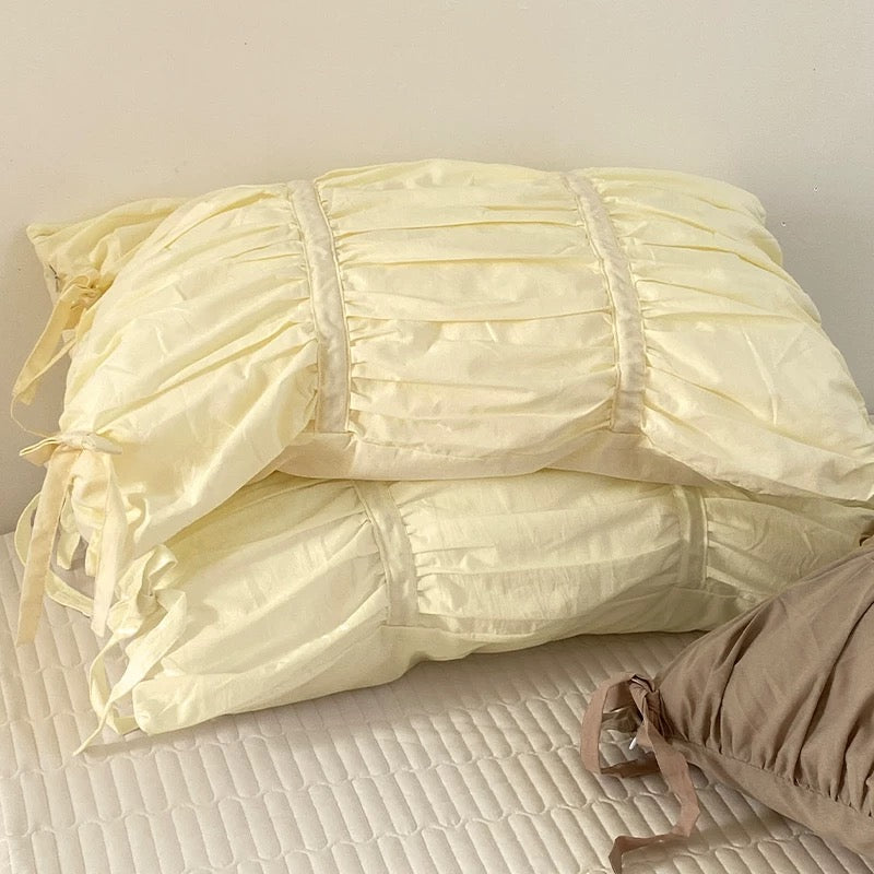 Aesthetic cotton pillow cover with pleated detail and bow accents, soft girl vibe.