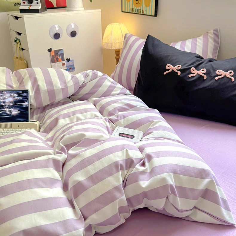 Close-up of lavender and white striped duvet cover showcasing the breathable cotton fabric