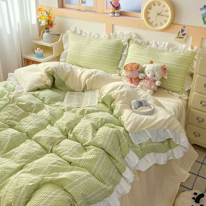Bedroom with green checkered bedding and decorative pillows.