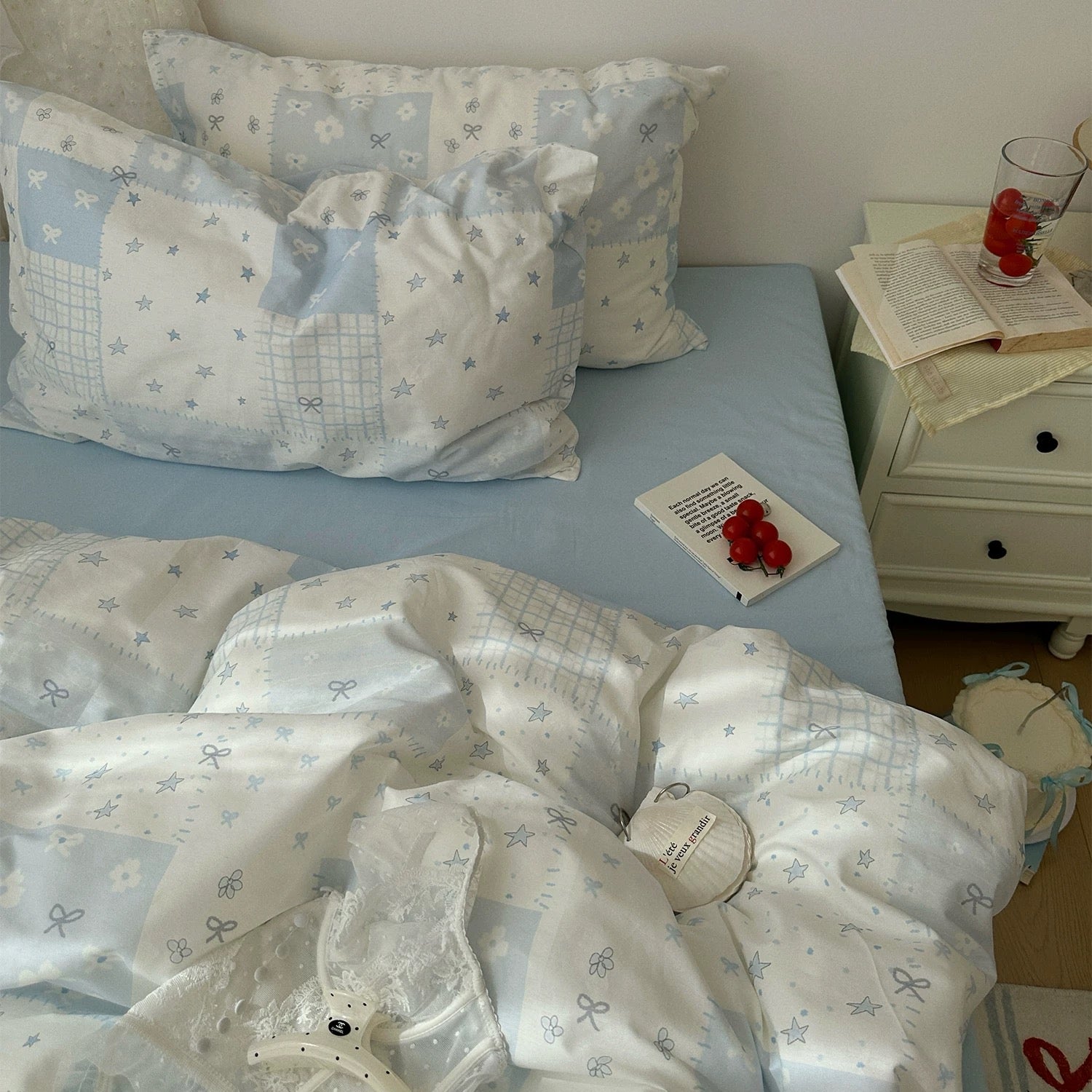 Kawaii pastel bedding set in blue patchwork design with bows and stars.