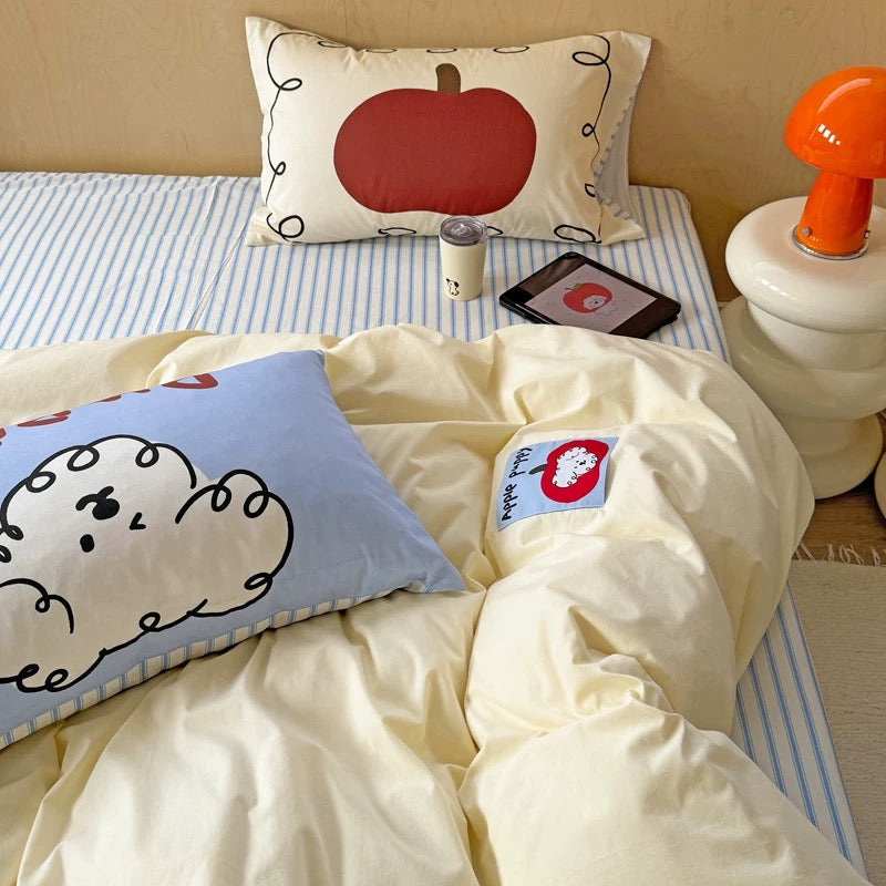 Puppy print pillow surrounded by minimalist room decor and tech