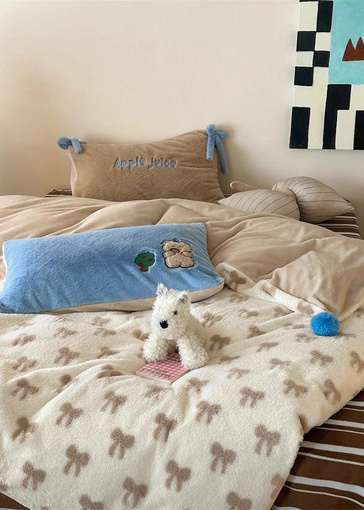 Dog lying on a bed with a patterned blanket, pillows, and a small painting on the wall.