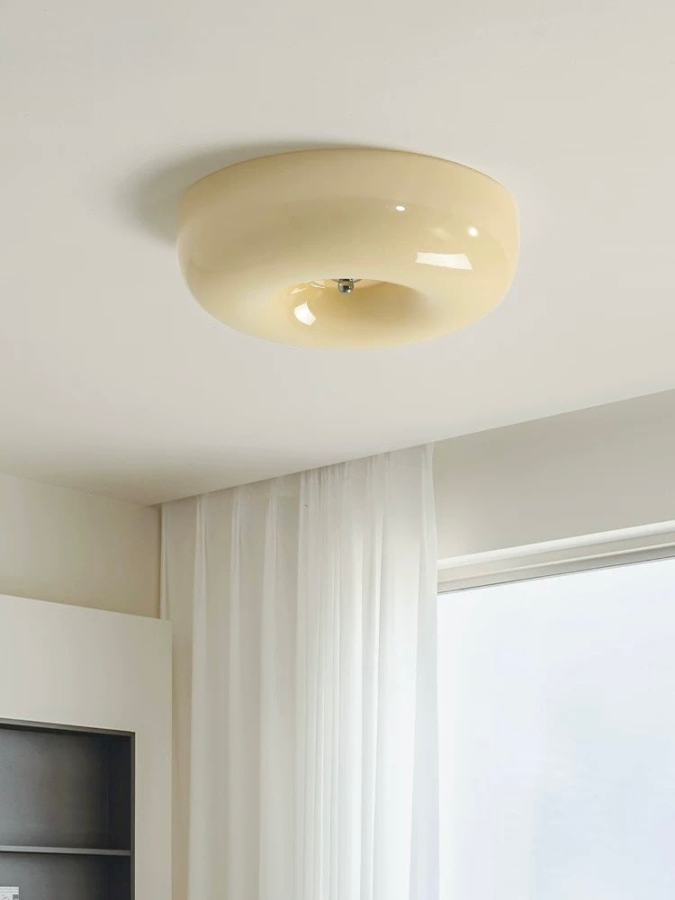 Ceiling light fixture in a room with a window and white walls