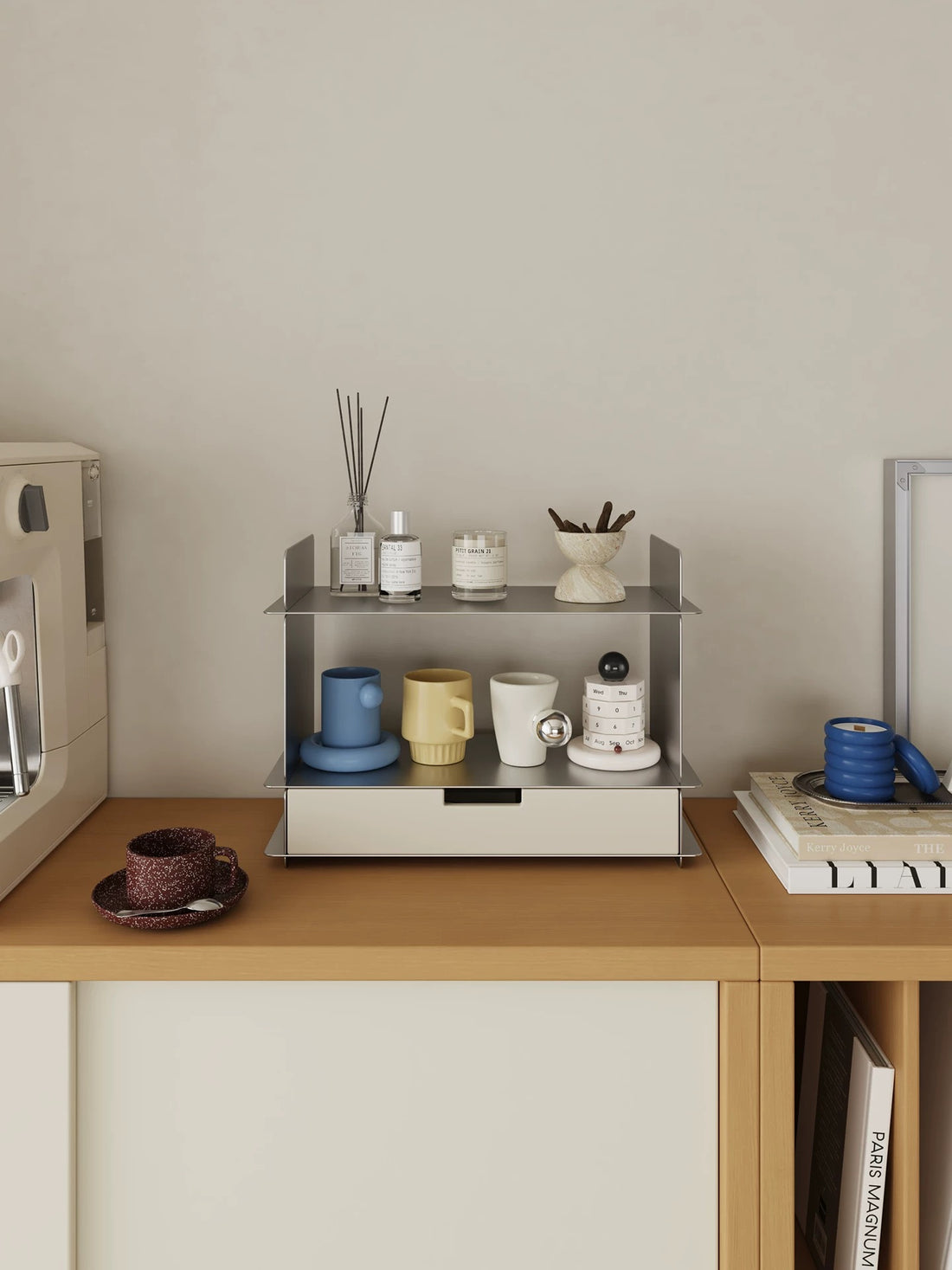 Desk shelf with a drawer on a white cabinet beside a green sign and a framed print