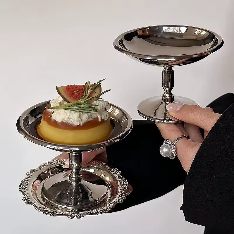 Silver tiered stand with a small dessert on a white background