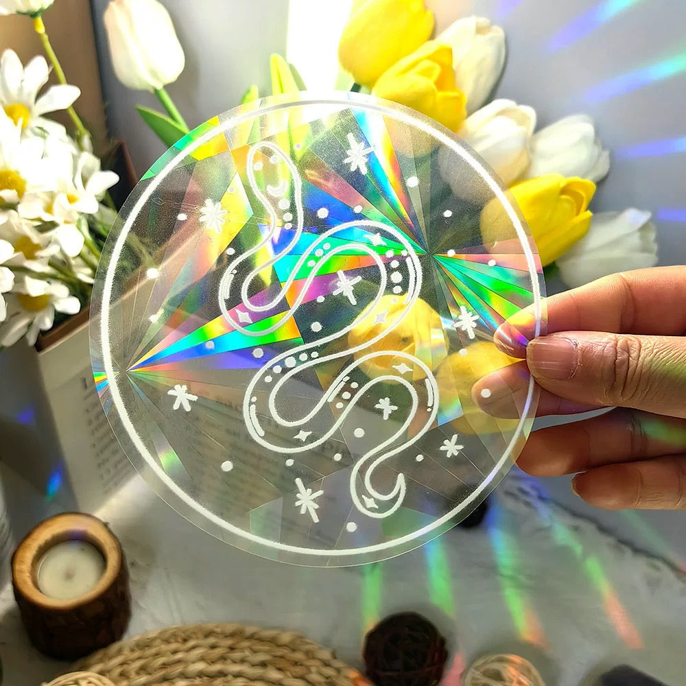 Witchy sun catcher sticker with moon, stars, and snakes
