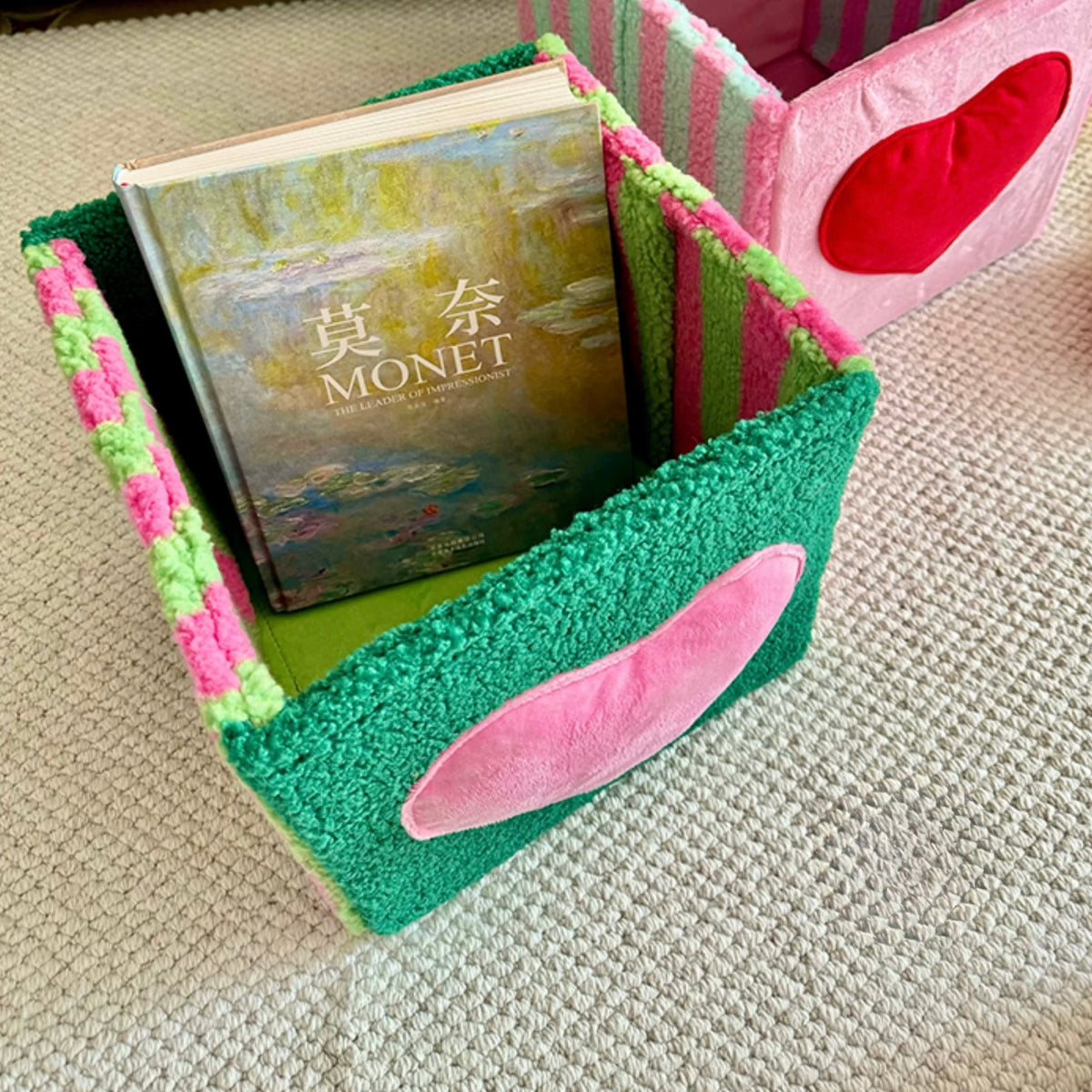 Open green storage stool holding books inside