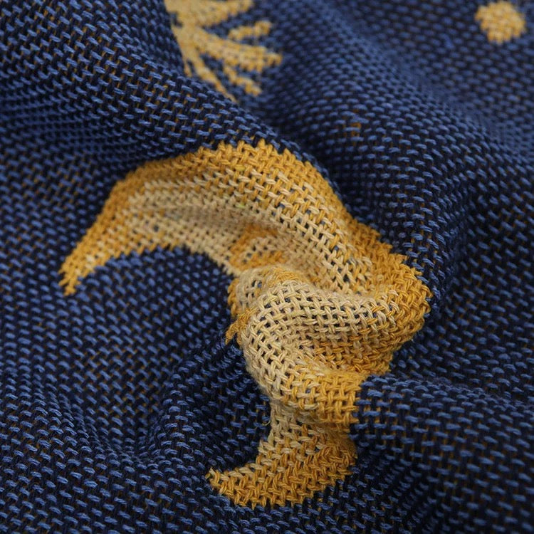 Close-up of blue fabric with yellow embroidered design