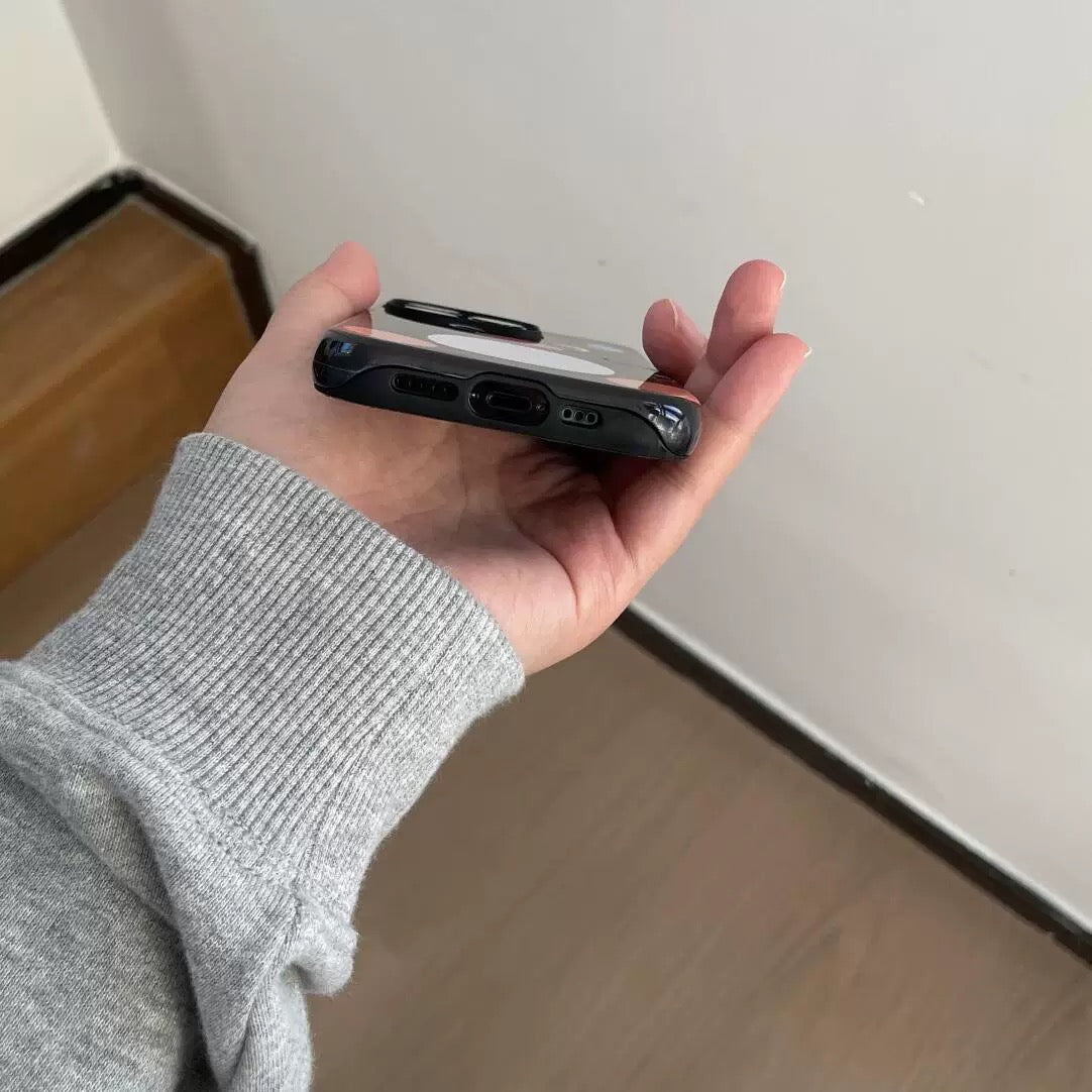 Hand holding a phone case with a plain background