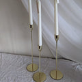 Tall candle sticks with gold, silver, and black finishes