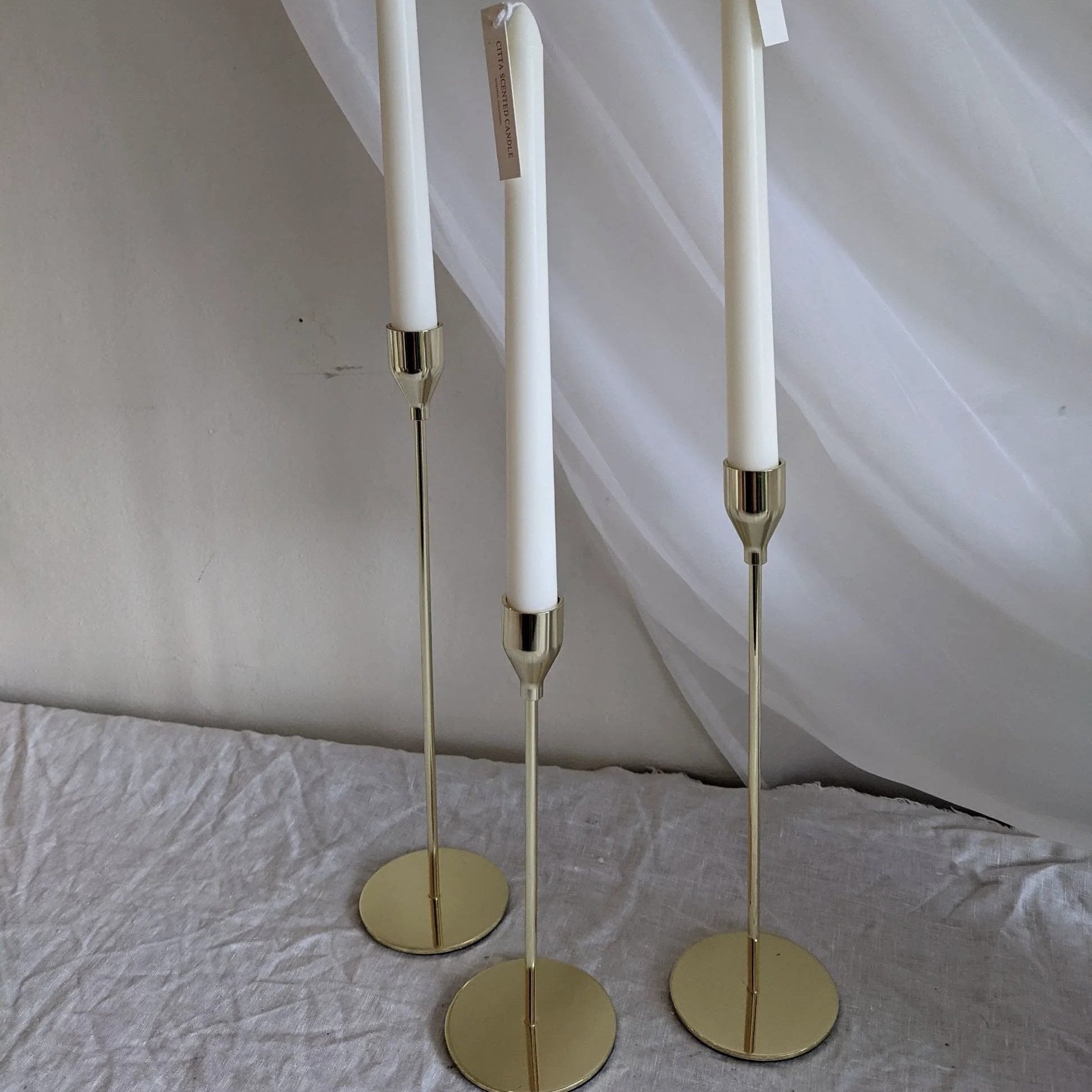 Tall candle sticks with gold, silver, and black finishes