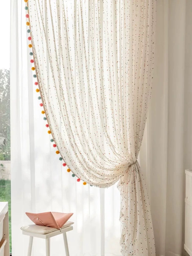Sheer boho curtain draped to the side, showing light filtering through.