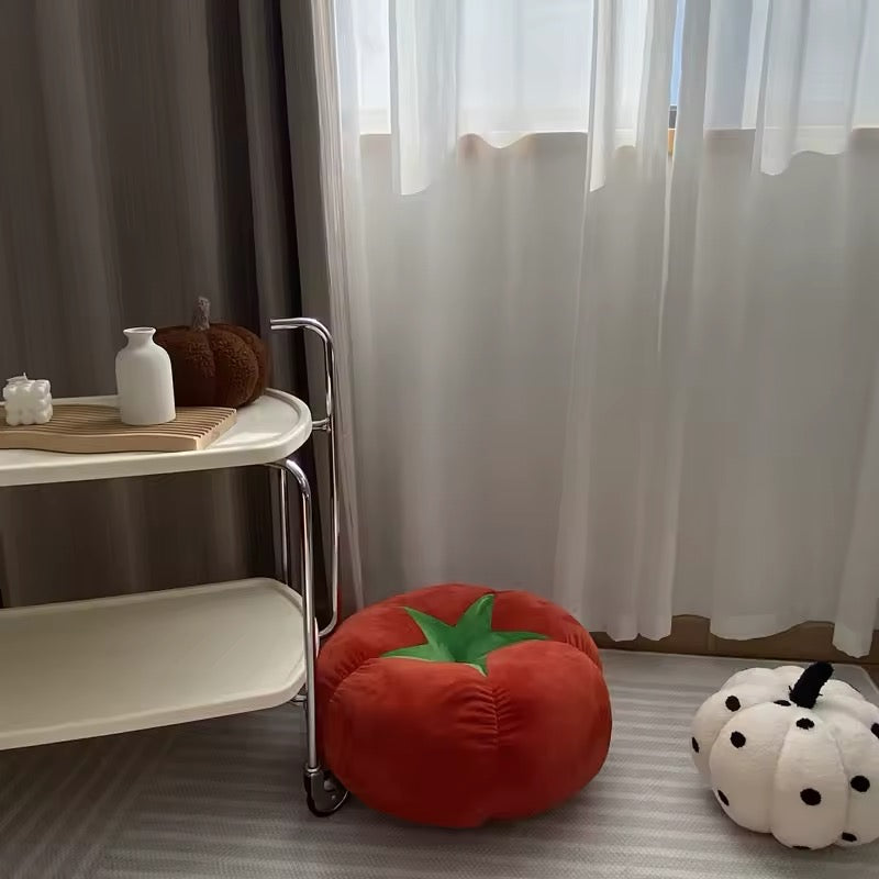 Tomato fruit cushion styled on white bedding