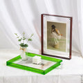 Transparent acrylic photo frame displayed on a modern table