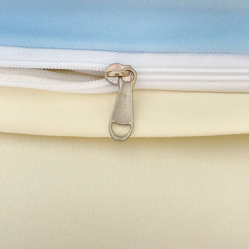 Close-up of a zipper on a product with a light blue top layer and beige bottom layer.