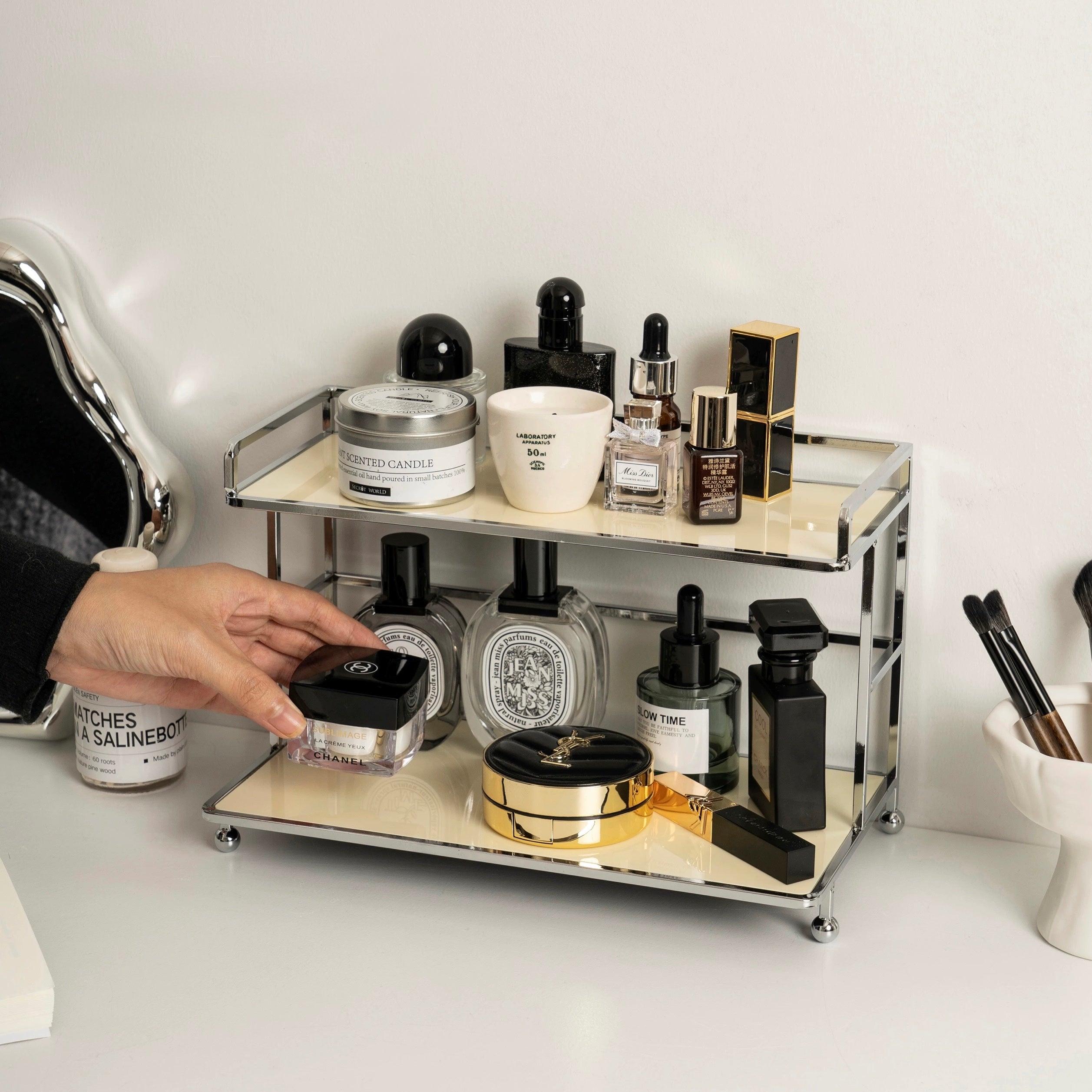 Cosmetic organizer with various skincare products on a white surface
