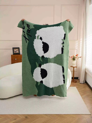 Light green sides and a green center surround the white sheep on a plush throw.