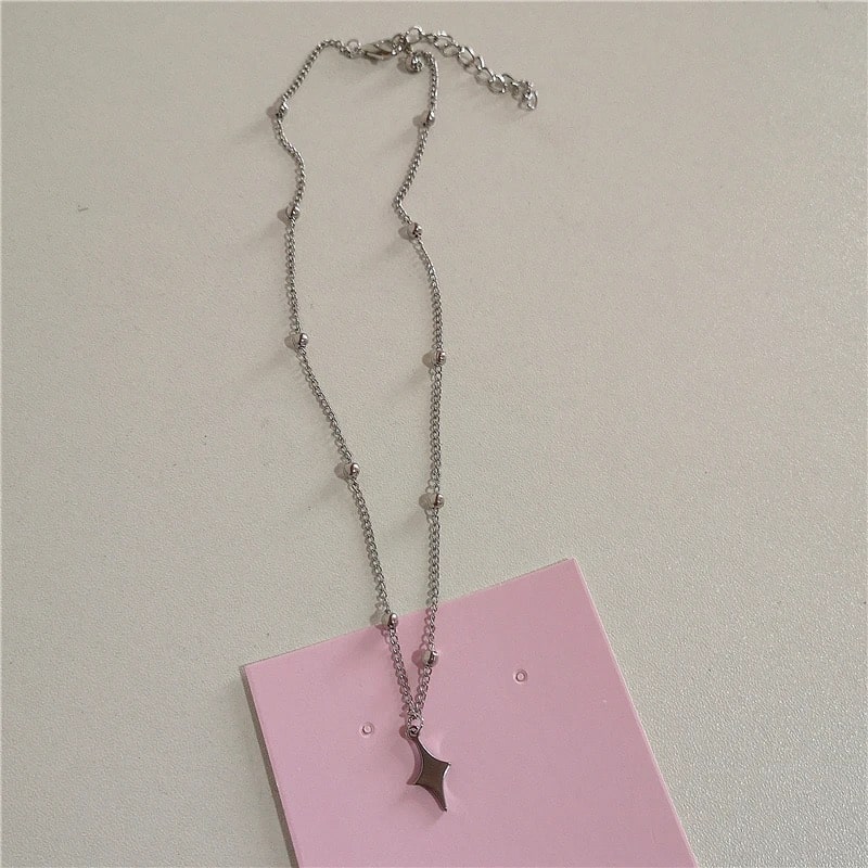 Fashionable pink beaded Y2K aesthetic choker necklace for women featuring gothic cross and wings pendant, perfect for 90s-inspired looks.