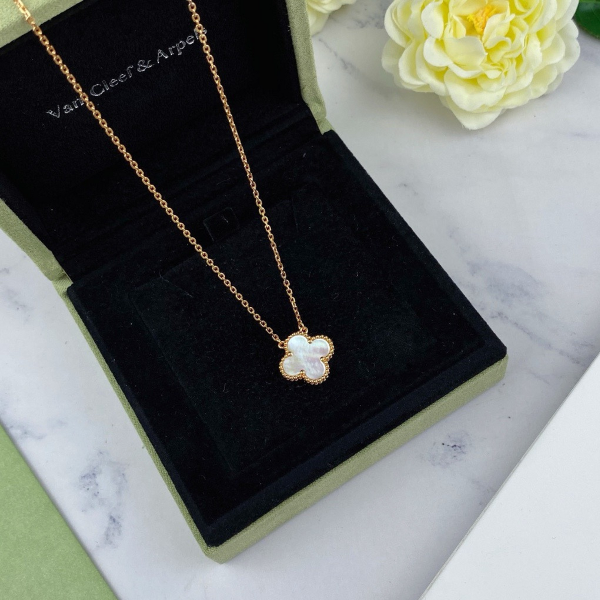 Elegant gold clover necklace with red pearl