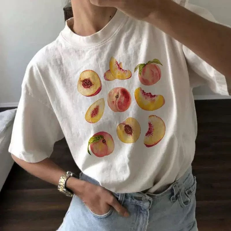 Vintage peaches t-shirt with nine-peach graphic print. Cottagecore aesthetic crop top for women’s casual summer Y2K and retro grunge style.