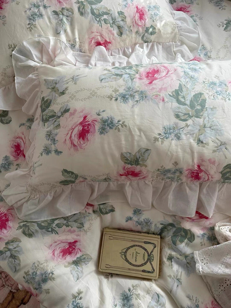 Pastel pink bedding set styled in a princesscore room with white furniture.