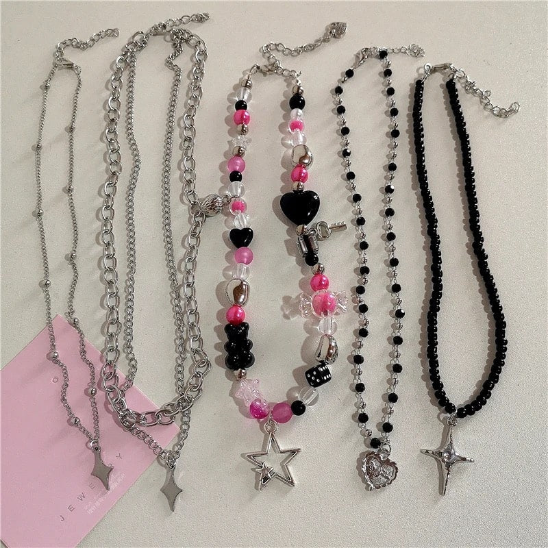 Vintage Y2K pink beaded choker necklace with gothic bow, cross, heart, and wings charms for emo and Harajuku style women’s fashion.