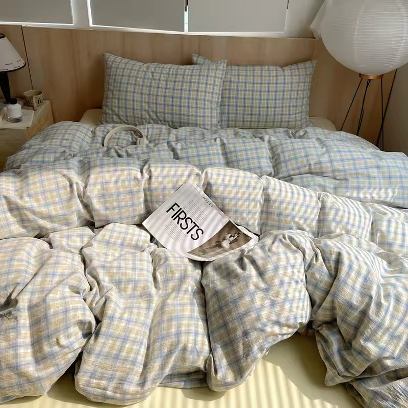Bed with checkered bedding and a magazine titled 'FIRSTS' on top.
