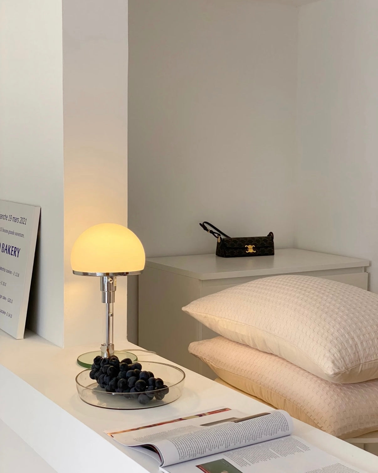 Compact mushroom desk lamp with glass base and warm light for small space styling.