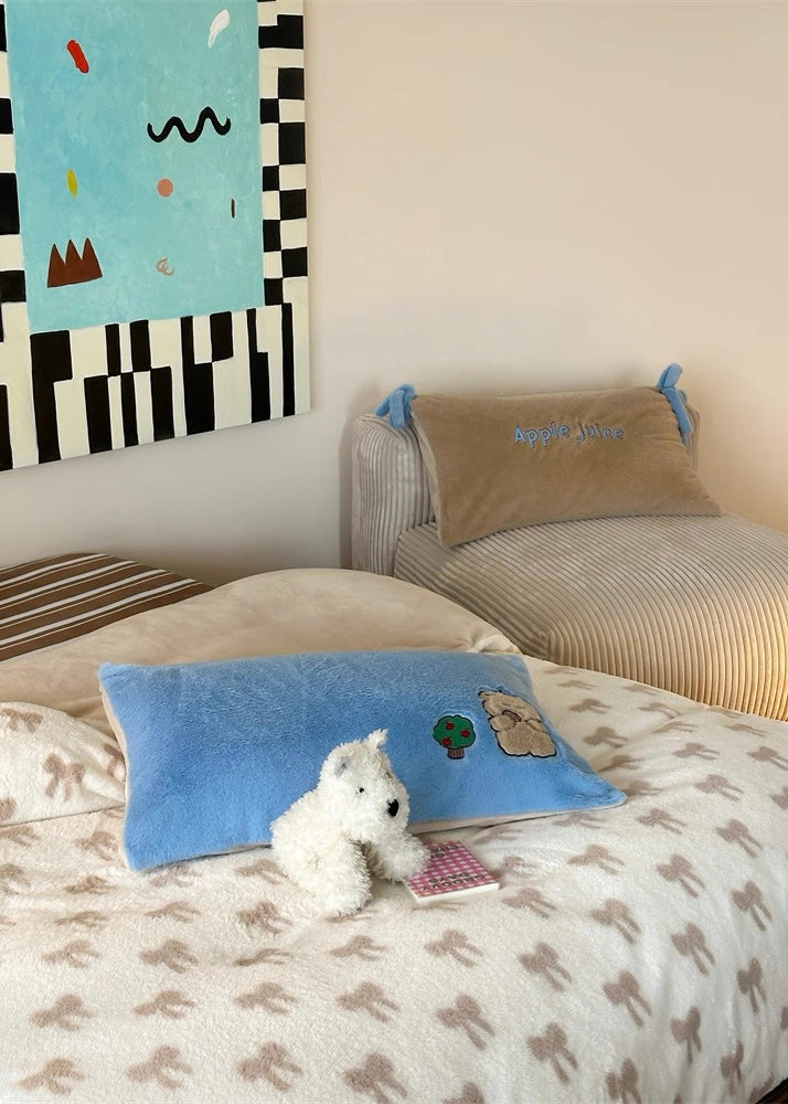 Children's bedroom with a bed, pillows, and a painting on the wall.