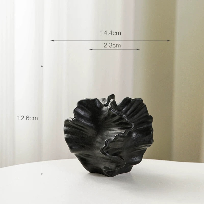 Black decorative vase with measurements on a white background