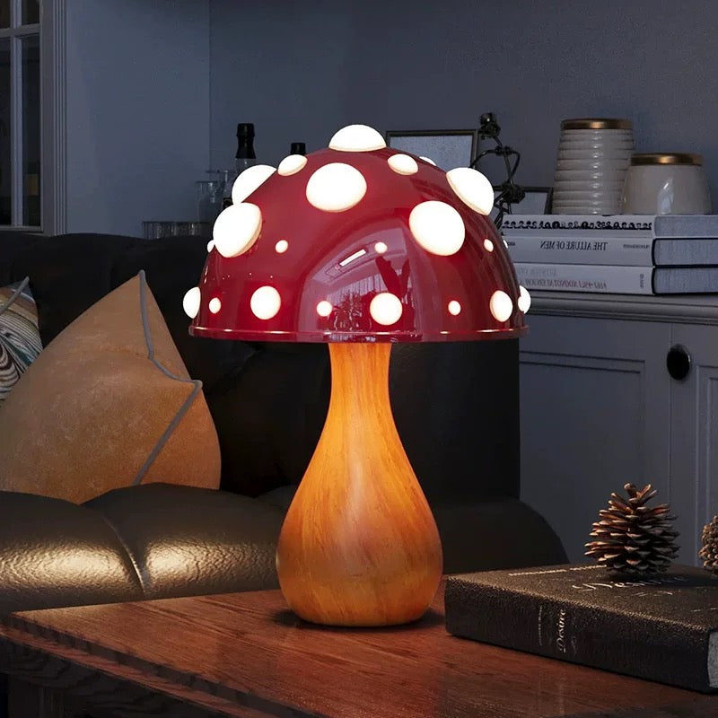 Mushroom-shaped lamp on a wooden surface with a cozy indoor setting.