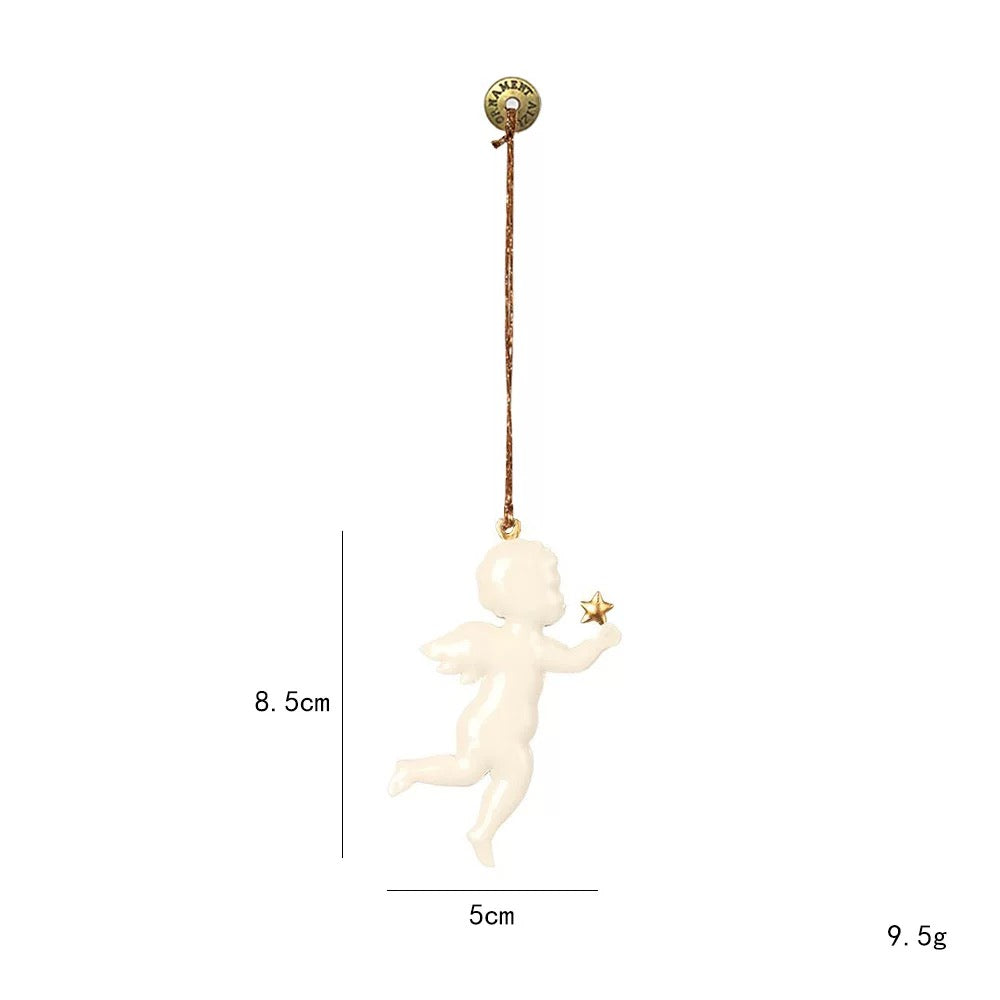 A white angel Christmas ornament has small wings, one raised leg and a gold star held in one hand.