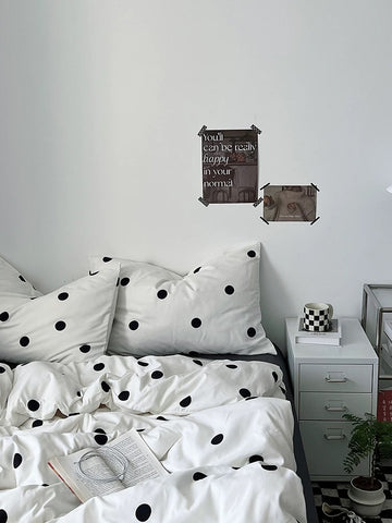 Bedroom with polka dot bedding and motivational poster on the wall