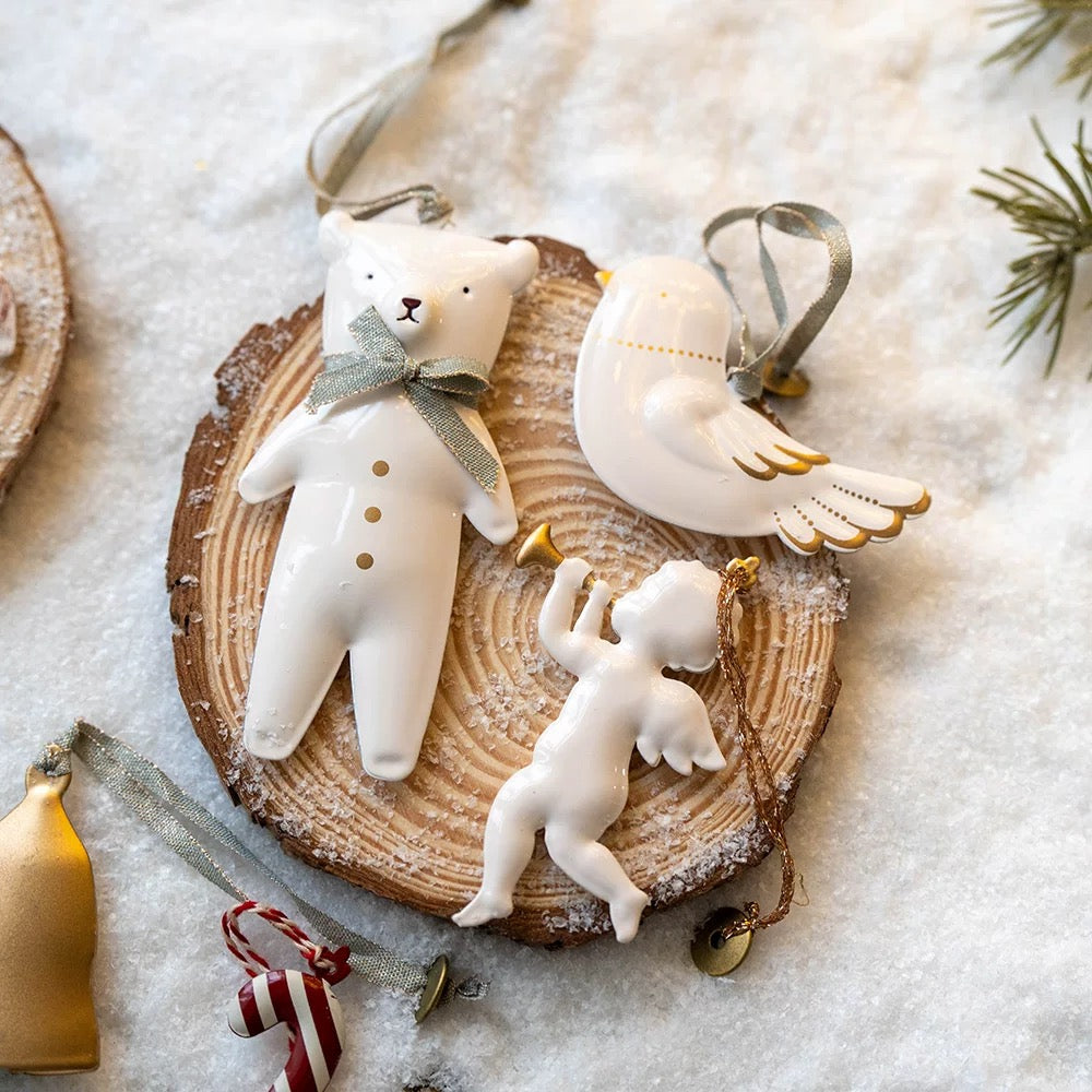 White Christmas ornaments include a polar bear with a gray bow, a gold trimmed dove and a small angel.