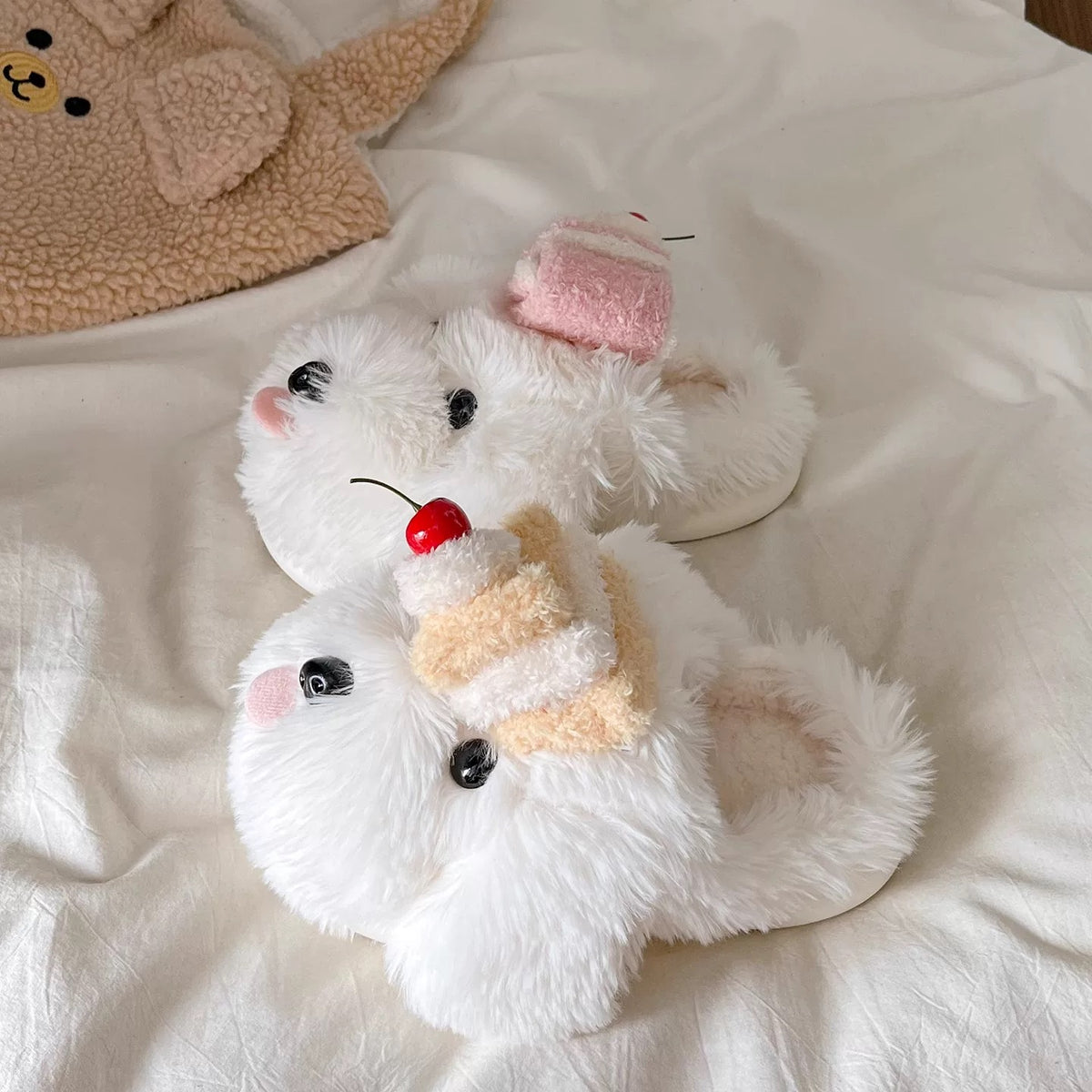 White cute dog slippers with plush puppy faces styled on bedding