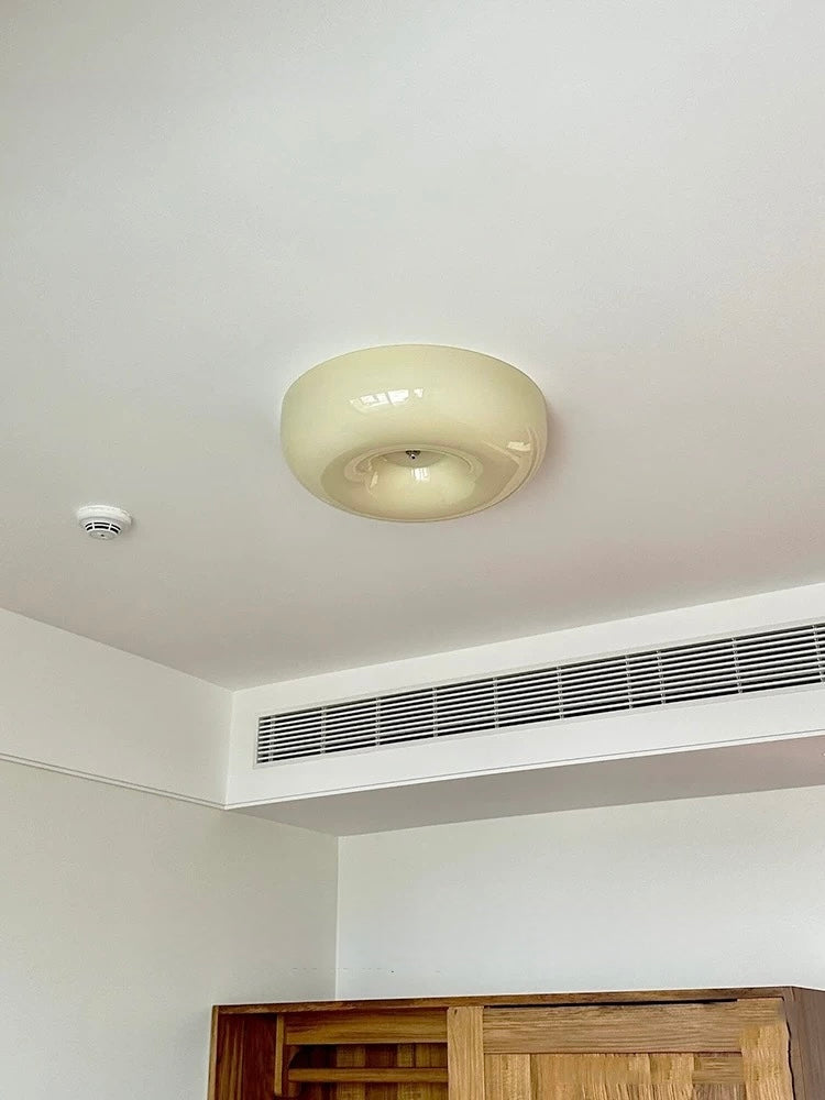 Ceiling light fixture in a room with an air conditioning unit below