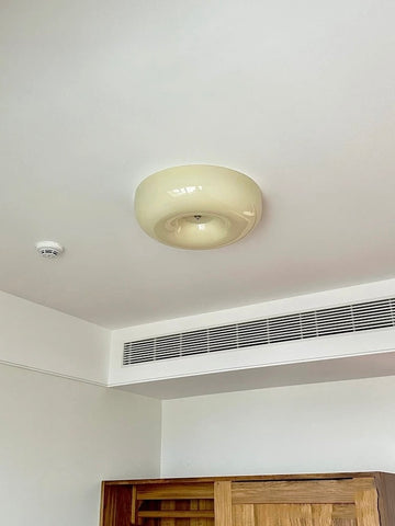 Ceiling light fixture in a room with an air conditioning unit below