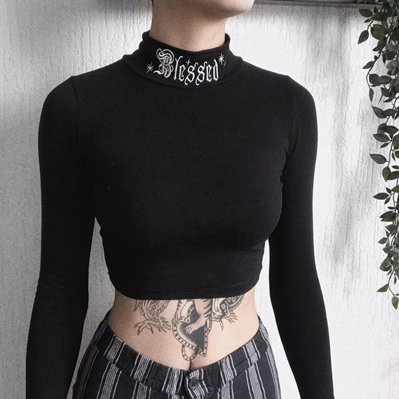 Black witchy crop top with Gothic letter embroidery. Long sleeve bodycon turtleneck design perfect for Harajuku and Y2K aesthetics.