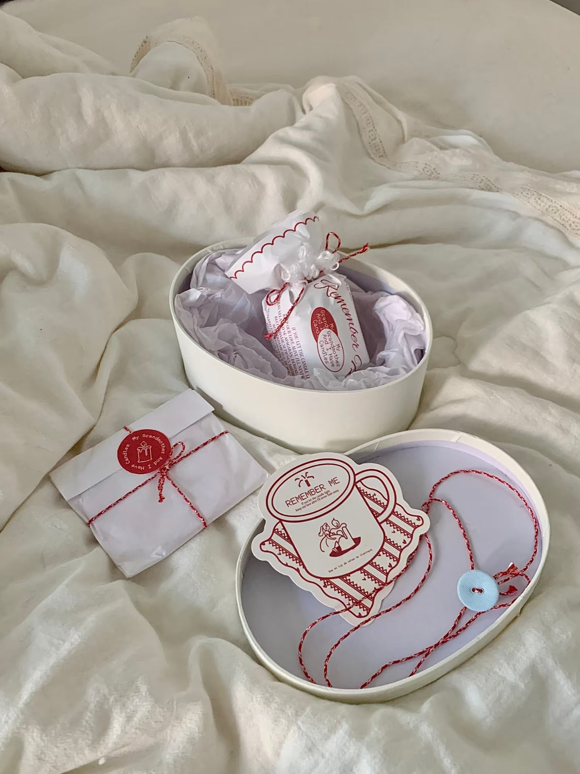 Wood wick candle gift box arranged on cream bedding