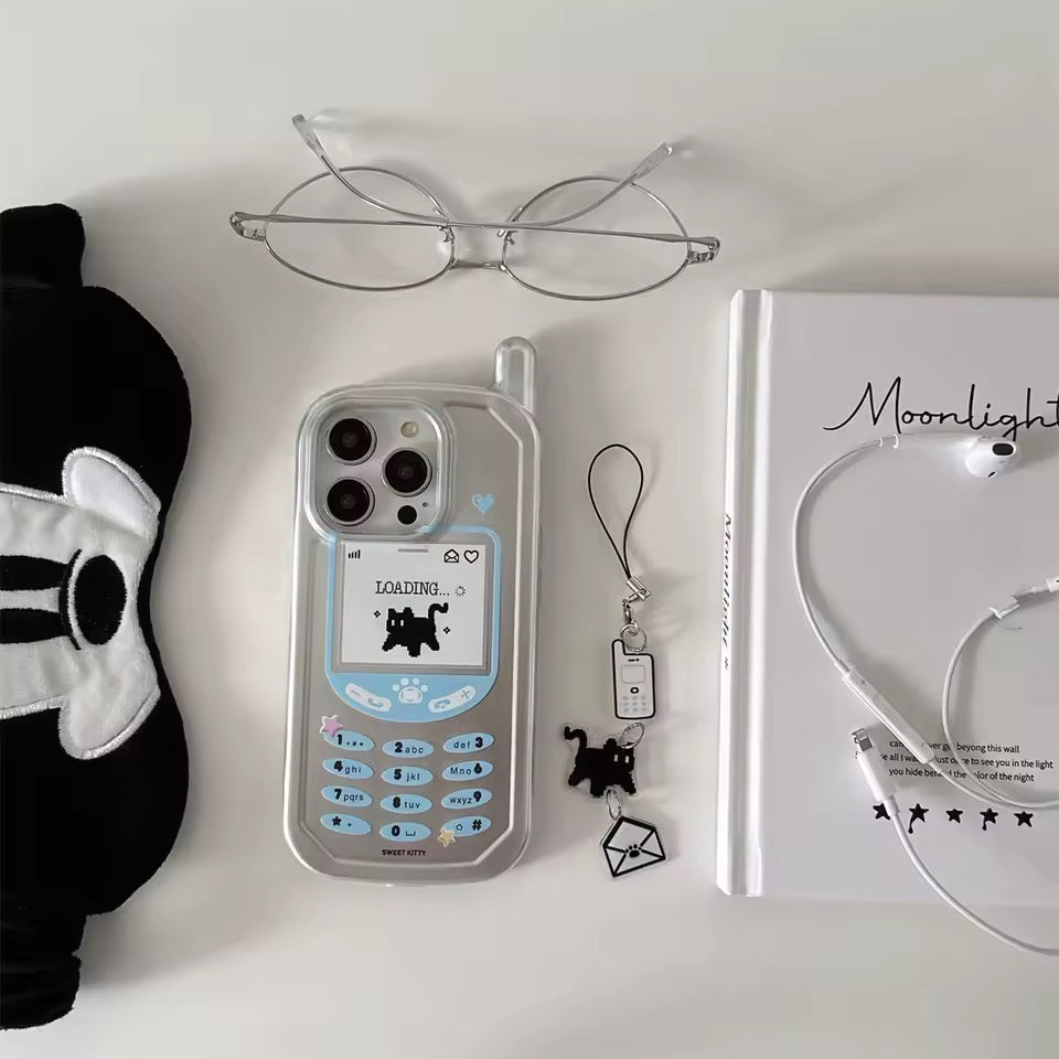 Phone case with loading screen design, glasses, panda mask, and book on a white surface