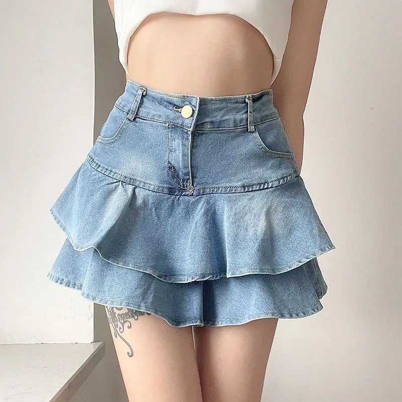 Y2K coquette vintage denim skirt with high-waist A-line design and pleated ruffles. Stylish blue mini skirt for women’s retro summer looks.