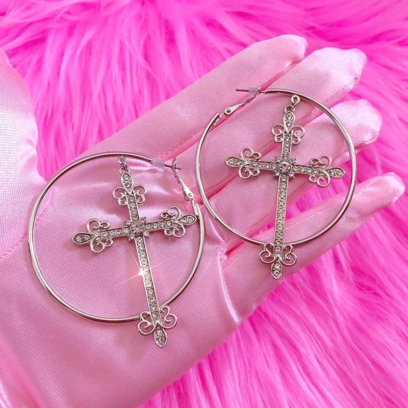 Y2K cross earrings with bling crystal hoops and gold finish. Punk aesthetic jewelry for bold 2000s-inspired fashion.