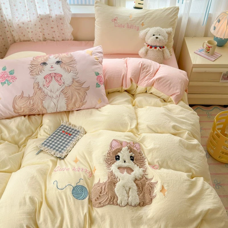 Cute bedroom with pink and yellow bedding featuring animal designs.