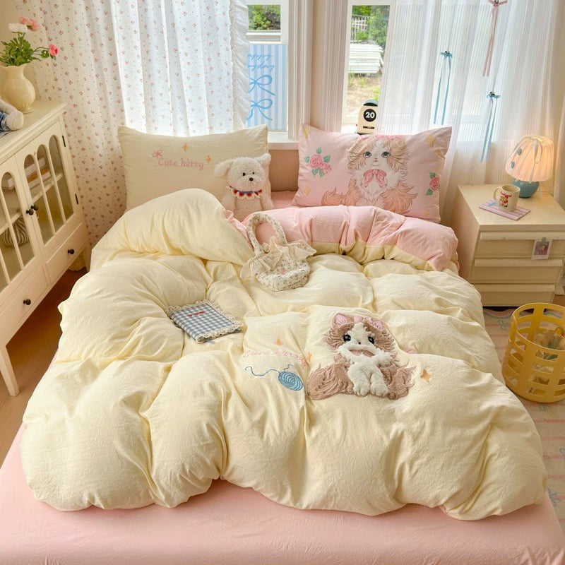 Bed with cartoon-themed bedding and pillows in a bright room.